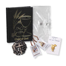 5-piece First Communion Gift Set in Black featuring a chalice Mass book, rosary, scapular, communion pin, and clear carrying case.